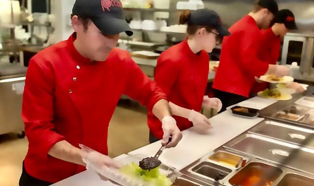 Rocoto staff preparing delicious food for a customer.